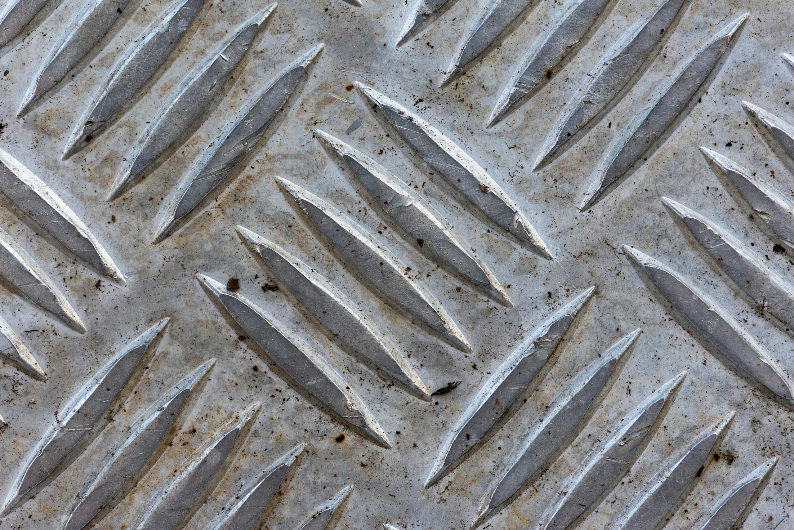 Close-up of a textured metal surface featuring a diamond plate pattern.